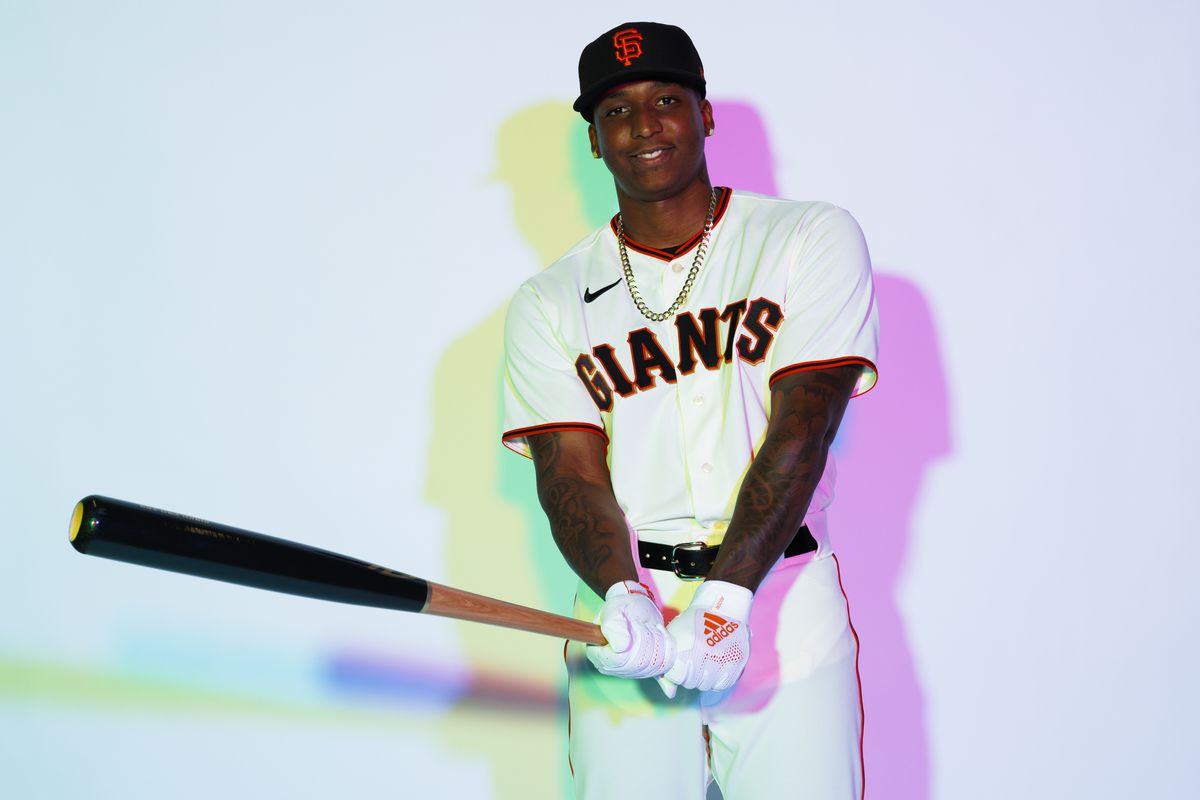 Marco Luciano posing for media day, holding a bat