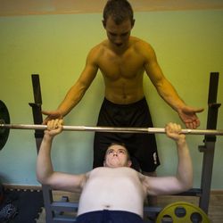 In this photo taken on Friday, Oct. 28, 2016, Russian youths help each other as they lift weights during training in Verkhnyaya Pyshma, just outside Yekaterinburg, Russia. The training has been run by Yunarmia (Young Army), an organization sponsored by the Russian military that aims to encourage patriotism among the Russian youth. 