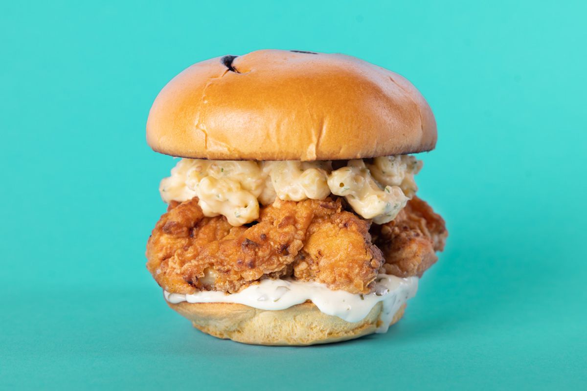 A fried chicken sandwich with mac and cheese.