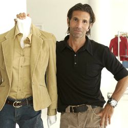 FILE - This May 15, 2002 file photo shows Los-Angeles based clothing designer Mossimo Giannulli posing with his fall preview clothing for Target department stores in New York. Giannulli and his wife, actress Lori Loughlin were charged along with nearly 50 other people Tuesday in a scheme in which wealthy parents bribed college coaches and other insiders to get their children into some of the most elite schools in the country, federal prosecutors said. (AP Photo/Kathy Willens, File)