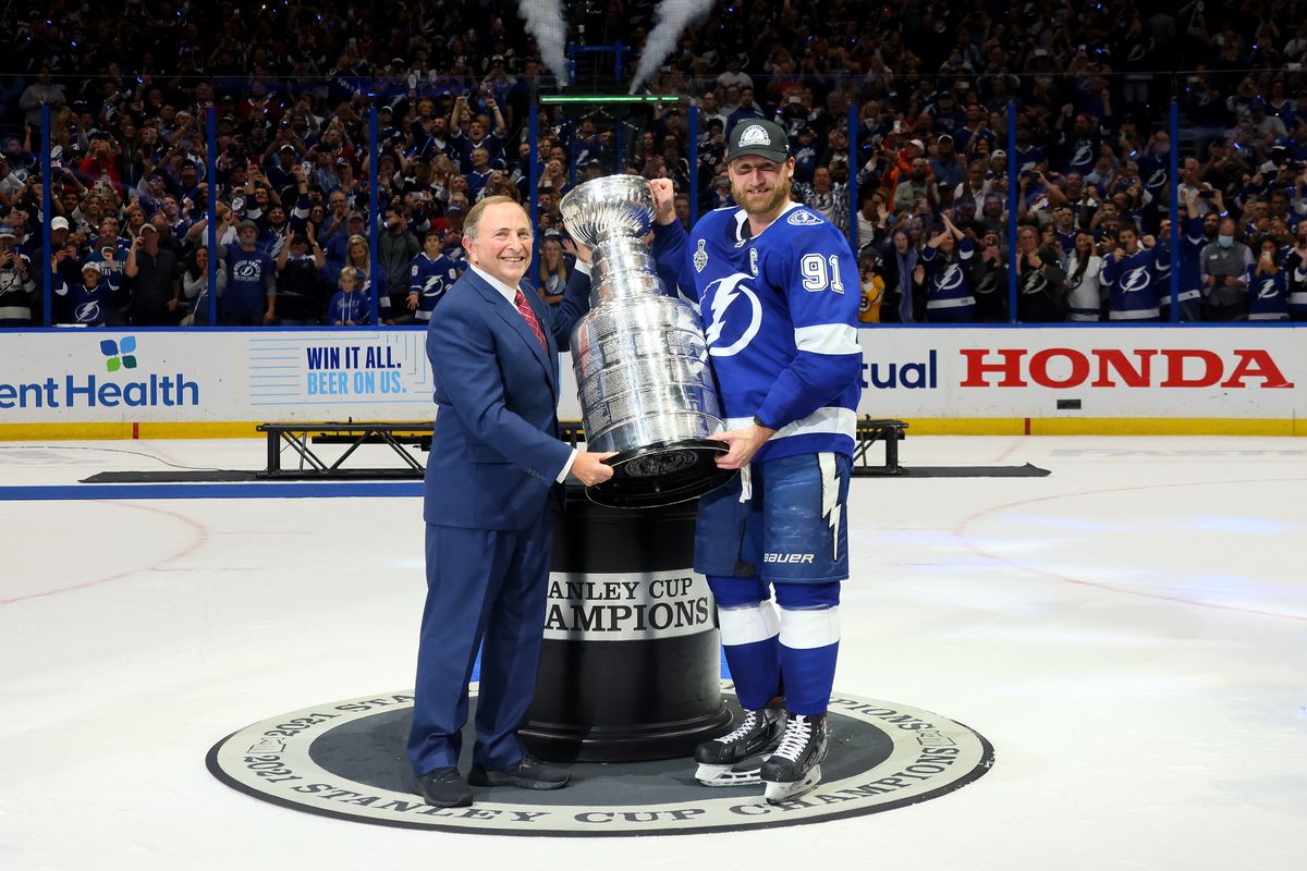 NHL Commissioner Gary Bettman presents Steven Stamkos #91 of the Tampa Bay Lightning with the Stanley Cup after the 1-0 victory against the Montreal Canadiens in Game Five to win the 2021 NHL Stanley Cup Final at Amalie Arena on July 07, 2021 in Tampa, Florida.