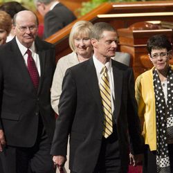 Elder Quentin L. Cook of the Quorum of the Twelve Apostles and his wife Mary and Elder David A. Bednar and his wife Susan walk off the stand after the afternoon session Saturday, April 6, 2013 of the 183th Annual General Conference of The Church of Jesus Christ of Latter-day Saints in the Conference Center.