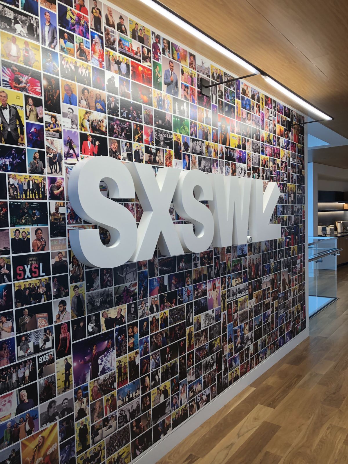 Wall with colorful photo montage and big white SXSW letters and arrow symbol on top