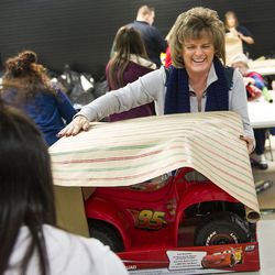 Collette Williams wraps a toy during the annual Giving Tree gift wrapping day in West Valley City on Tuesday, Dec. 20, 2016. The program will enable 58 low-income families to brighten 171 children's Christmas day with gifts.