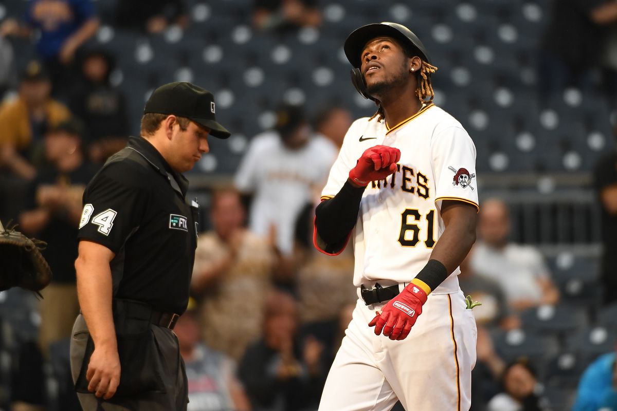 Oneil Cruz #61 of the Pittsburgh Pirates reacts as he crosses home plate after hitting a two run home run for his first Major League home run in the ninth inning during the game against the Cincinnati Reds at PNC Park on October 3, 2021 in Pittsburgh, Pennsylvania.