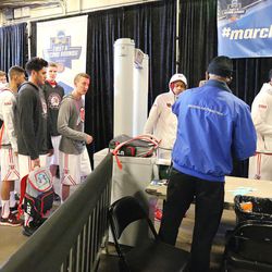 Utah Utes walk through a metal detector at the Pepsi Center prior to their NCAA basketball tournament second round game in Denver,  Saturday, March 19, 2016. 