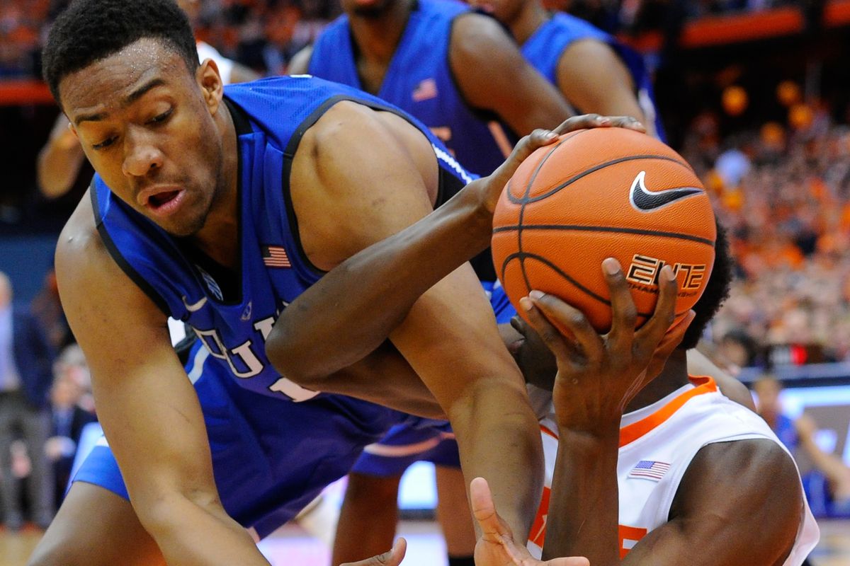 Jabari Parker #1 of the Duke Blue Devils reaches to knock the ball from the hands of Jerami Grant #3 of the Syracuse Orange during the first half at the Carrier Dome on February 1, 2014 in Syracuse, New York. 