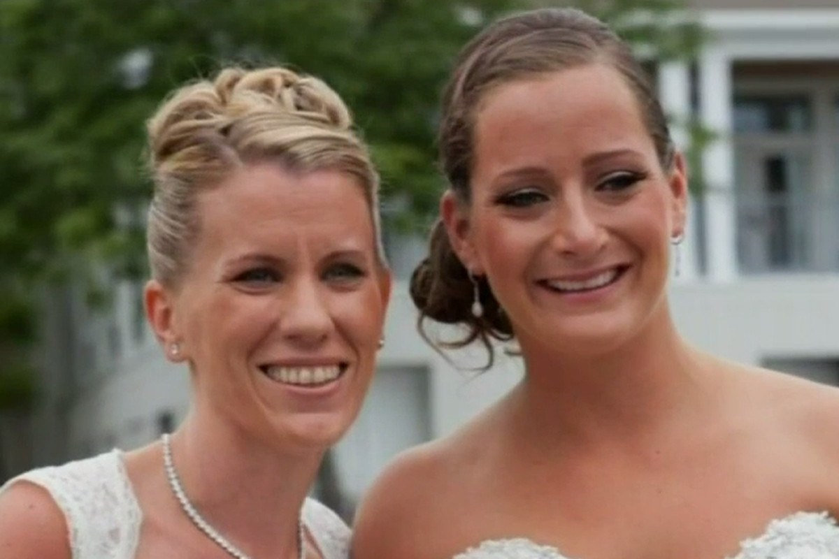 Kate Drumgoole (left) and her wife on their wedding day. It was their marriage that ultimately led a Catholic school to fire her.