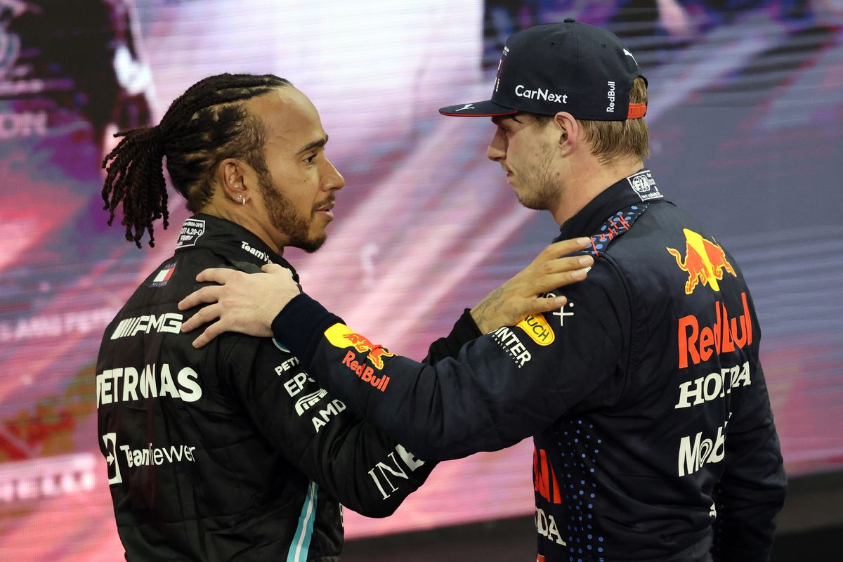 Max Verstappen (NDL) Red Bull Racing, RB16B, Honda engine and Lewis Hamilton (GBR) Mercedes AMG F1 Team after winning the final race during the Grand Prix Formula One of Abu Dhabi at Yas Marina Circuit on December 12, 2021 in Abu Dhabi, United Arab Emirates.