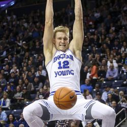 Brigham Young Cougars forward Eric Mika (12) dunks a basket during the game at BYU's Marriott Center in Provo on Saturday, Jan. 28, 2017. The Cougars led 43 to 40 heading into the second half. 