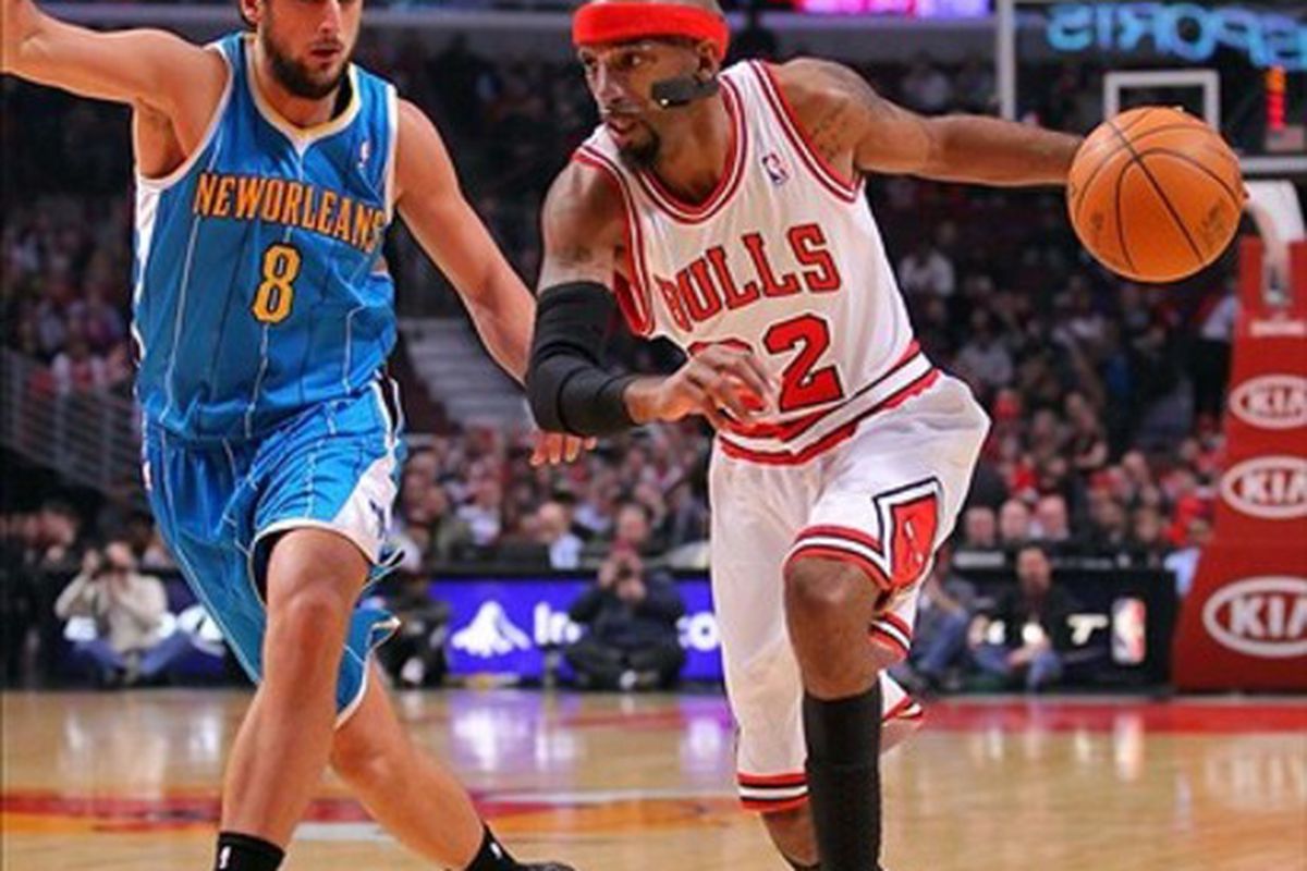 Feb 28, 2012; Chicago, IL, USA; Chicago Bulls shooting guard Richard Hamilton (32) drives past New Orleans Hornets shooting guard Marco Belinelli (8) during the first half at the United Center. Mandatory Credit: Dennis Wierzbicki-US PRESSWIRE
