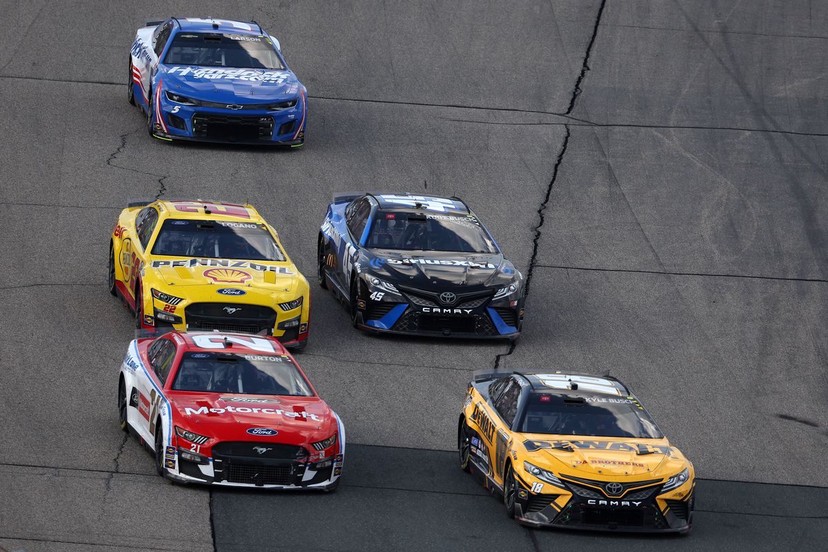 Kyle Busch, driver of the #18 DeWalt Toyota, Harrison Burton, driver of the #21 Motorcraft/Quick Lane Ford, Joey Logano, driver of the #22 Shell Pennzoil Ford, Kurt Busch, driver of the #45 SiriusXM Radio Toyota, and Kyle Larson, driver of the #5 HendrickCars.com Chevrolet, race during the NASCAR Cup Series Ambetter 301 at New Hampshire Motor Speedway on July 17, 2022 in Loudon, New Hampshire.