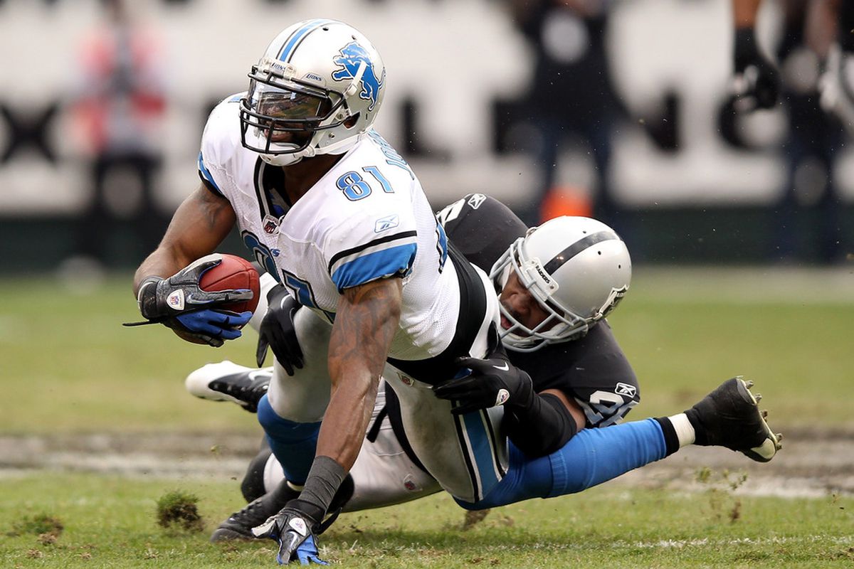 OAKLAND, CA - DECEMBER 18:  Calvin Johnson #81 of the Detroit Lions is tackled by Stanford Routt #26 of the Oakland Raiders at O.co Coliseum on December 18, 2011 in Oakland, California.  (Photo by Ezra Shaw/Getty Images)