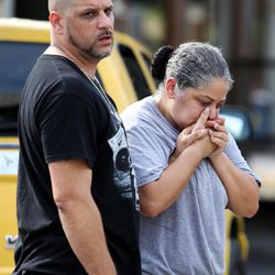 Ray Rivera, left, a DJ at Pulse Orlando nightclub, is consoled by a friend, outside of the Orlando Police Department after a shooting involving multiple fatalities at the nightclub, Sunday, June 12, 2016, in Orlando, Fla.