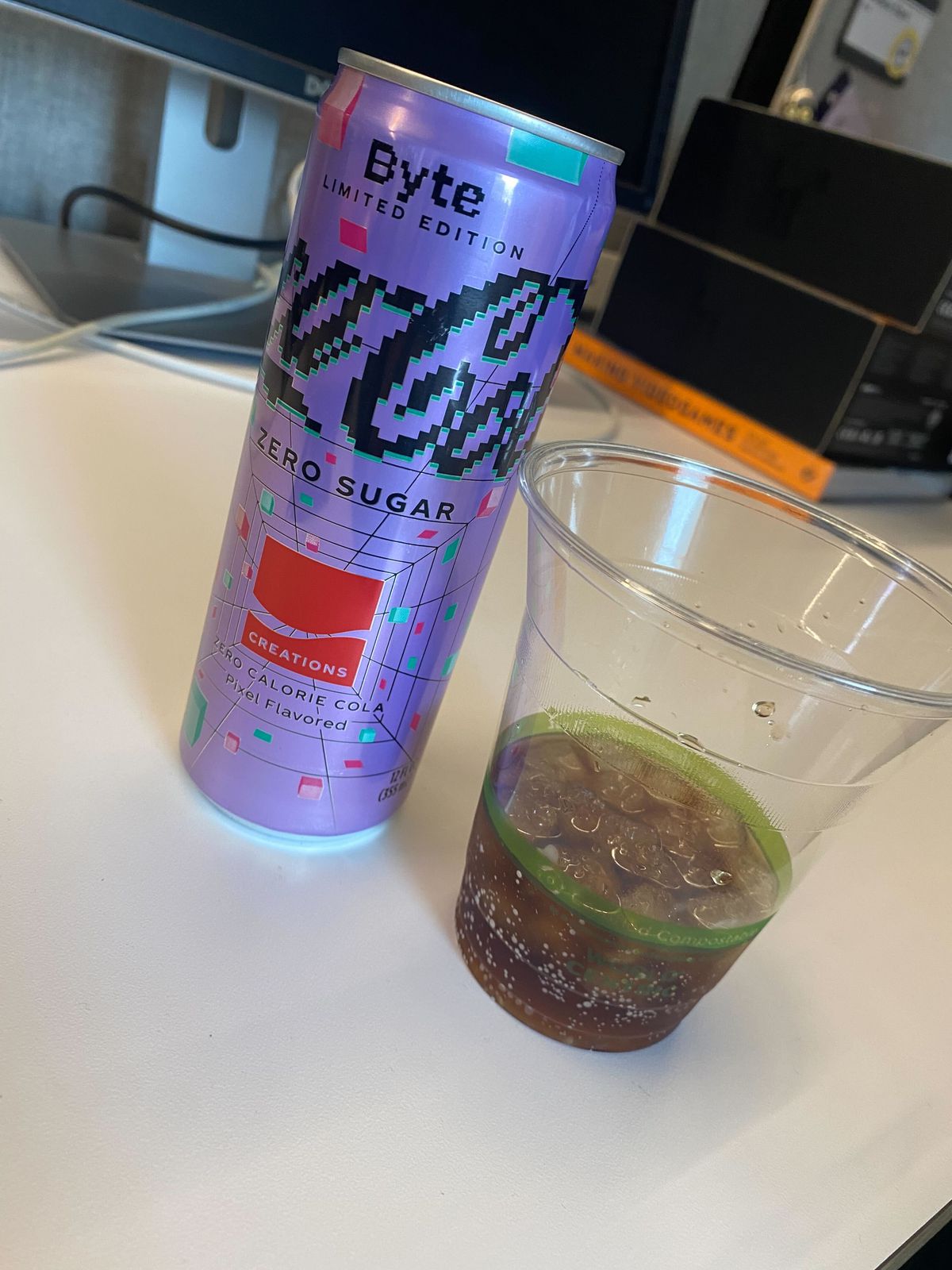 a can of Coca-Cola Zero Sugar Byte  and a cup of poured Coca-Cola Zero Sugar Byte 