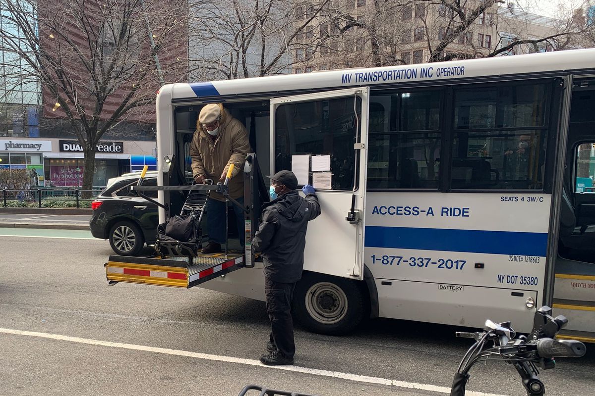 A man is lowered by an Access-A-Ride vehicle in Union Square.