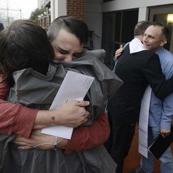 Justin Morgan, left, and Glenn Cannon, right, hug supporters after getting their marriage license at the Montgomery County Probate Office in Montgomery, Ala. on Monday Febr. 9, 2015. Gay couples began getting married in Alabama on Monday morning, despite an 11th-hour attempt from the state’s chief justice to block the weddings.  