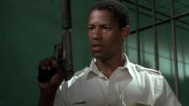 Denzel Washington holding a silencer-equipped pistol in The Mighty Quinn