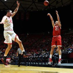 Utah forward Tyler Rawson shoots the ball over forward Marc Reininger during the team's season opening showcase, Night with the Runnin' Utes, at the Huntsman Center in Salt Lake City on Tuesday, Oct. 18, 2016.