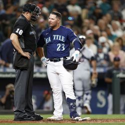 SEATTLE, WASHINGTON - AUGUST 27: Ty France #23 of the Seattle Mariners reacts with umpire Lance Barrett #16 after striking out during the fourth inning against the Cleveland Guardians at T-Mobile Park on August 27, 2022 in Seattle, Washington.      