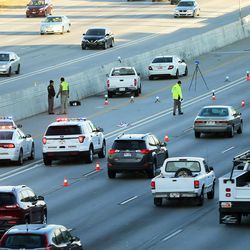 Utah Highway Patrol troopers investigate an auto-pedestrian accident in the northbound left lanes of I-15 near 5400 South on Friday, Nov. 18, 2016.