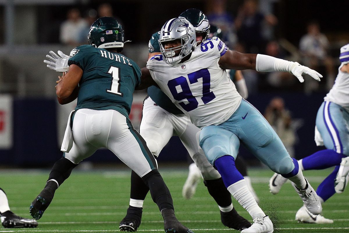 Osa Odighizuwa #97 of the Dallas Cowboys goes to sack Jalen Hurts #1 of the Philadelphia Eagles in the first half at AT&amp;T Stadium on September 27, 2021 in Arlington, Texas.