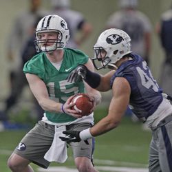 Quarterback Ammon Olsen hands off to Michael Alisa on the first day of BYU football's spring camp Monday, March 4, 2013, in Provo. Alisa and teammate Jamaal Williams will compete for carries in the BYU backfield this year.