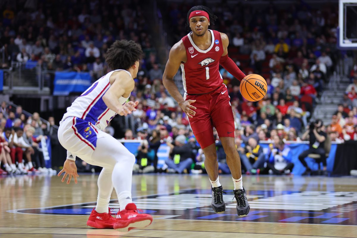 Ricky Council IV #1 of the Arkansas Razorbacks dribbles the ball against Jalen Wilson #10 of the Kansas Jayhawks during the first half in the second round of the NCAA Men’s Basketball Tournament at Wells Fargo Arena on March 18, 2023 in Des Moines, Iowa.
