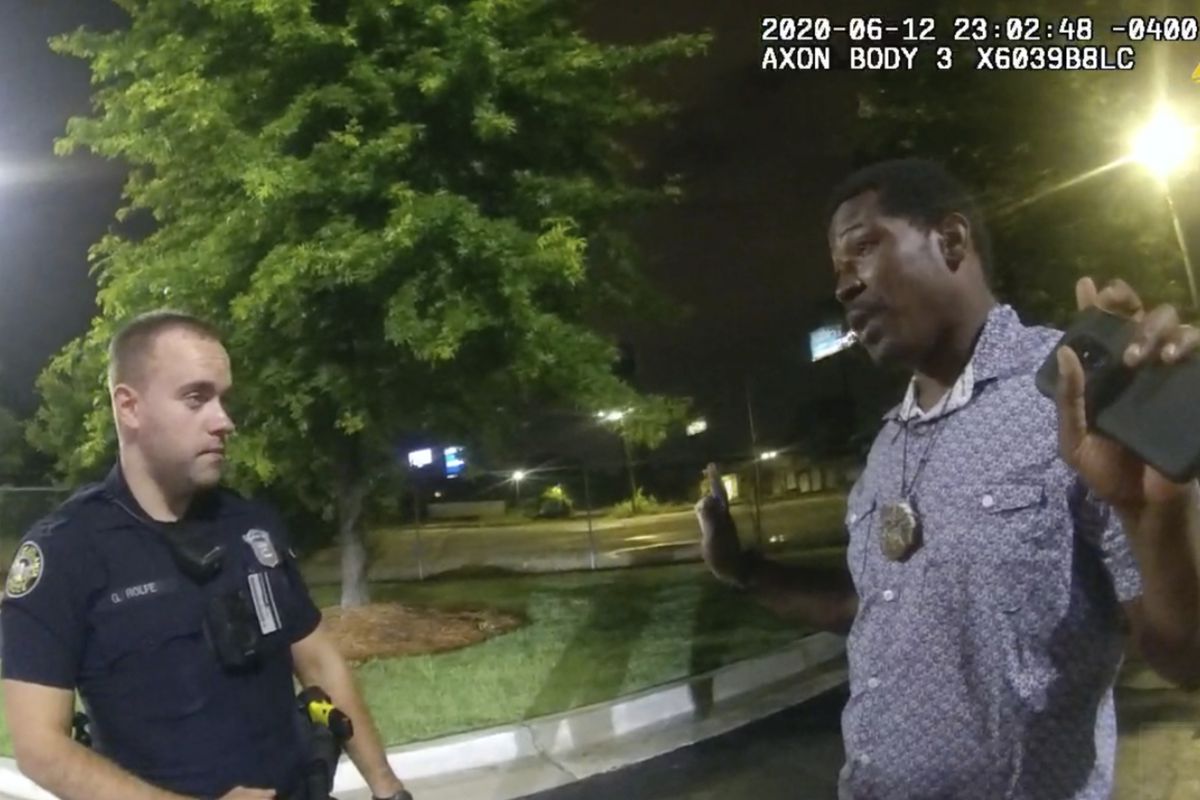 This screen grab taken from body camera video provided by the Atlanta Police Department shows Rayshard Brooks speaking with Officer Garrett Rolfe, left, in the parking lot of a Wendy’s restaurant, late Friday, June 12, 2020, in Atlanta. 