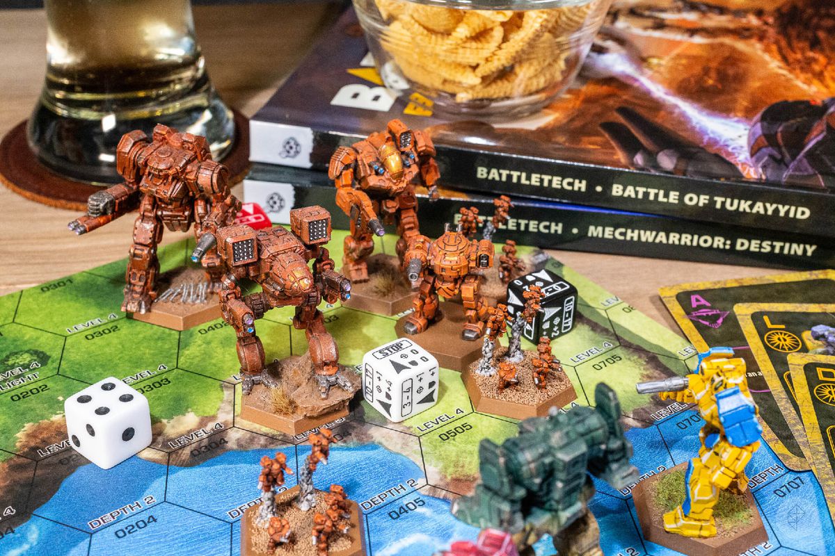 Battletech miniatures engaged in combat. Beer and peanuts for flavor.