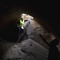 Workers stand in an ancient cistern underneath a 1,500-year-old street located 4.3 meters (14 feet) below ground level, revealed by the Israeli Antiquities Authority in the old city of Jerusalem, Wednesday.