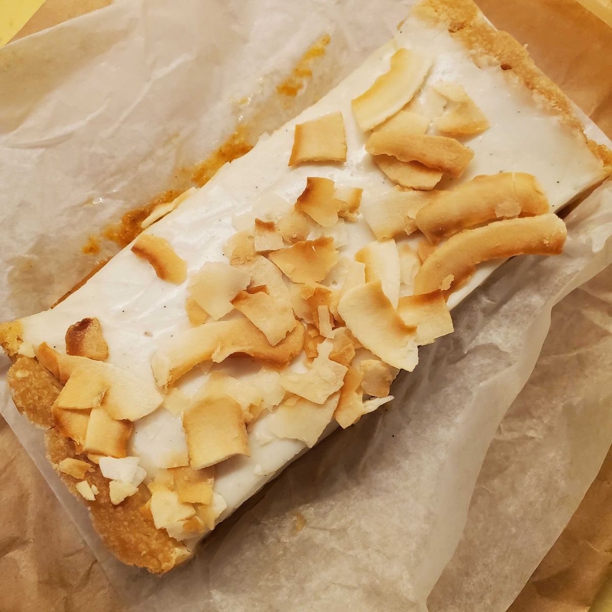 An up-close picture of a pumpkin-haupia shortbread bar from pop-up Not Too Sweet.