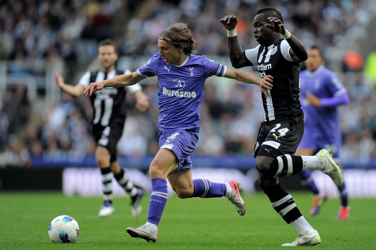 Luka Modric of Tottenham Hotspur holds off Cheik Tiote of Newcastle United