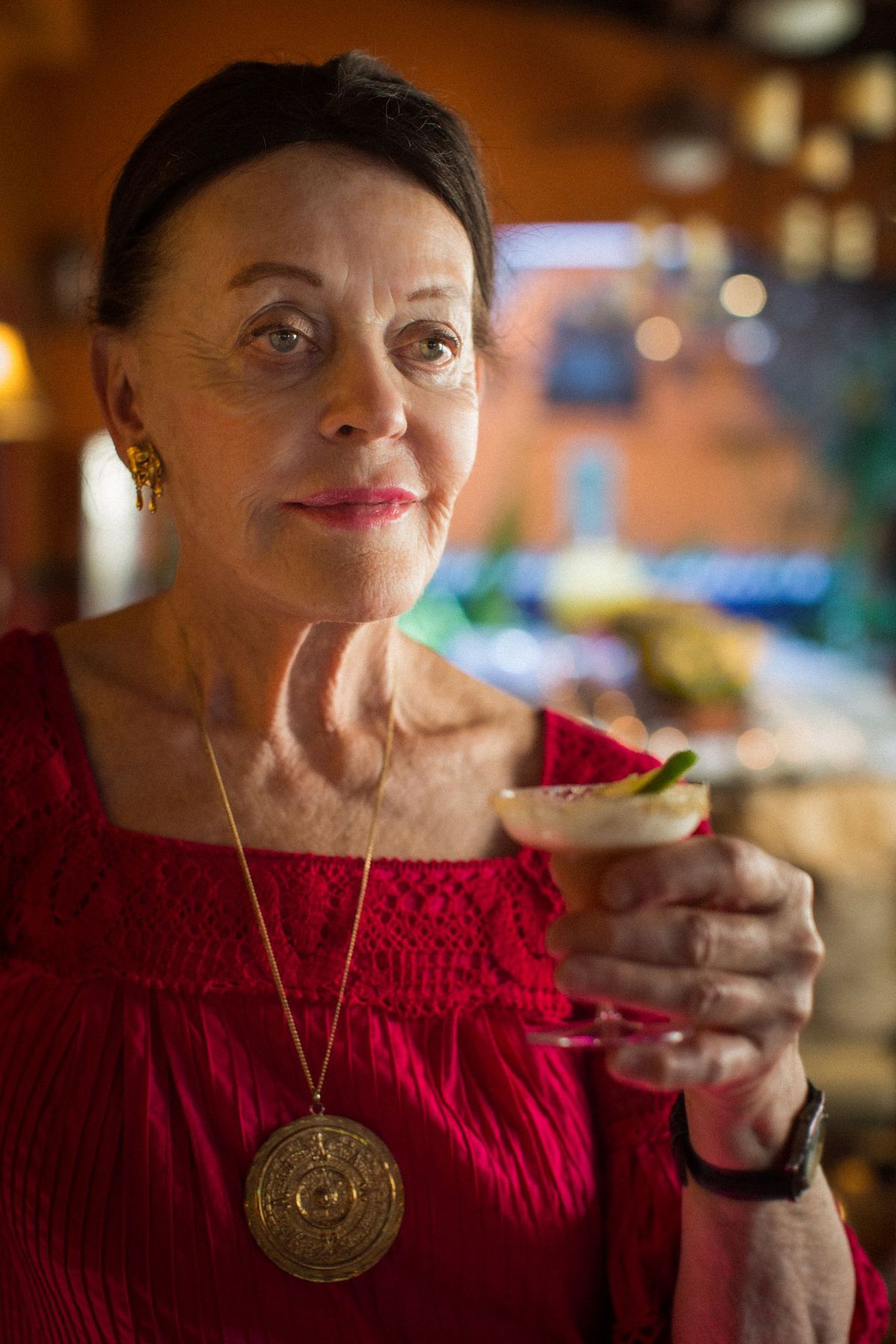 Barbara Hansen holding up a cocktail in 2014.