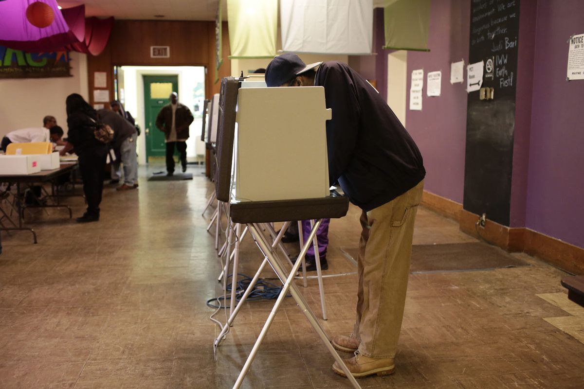A man fills out his ballot at a polling station during the midterm elections Nov. 4, 2014 in Detroit.
