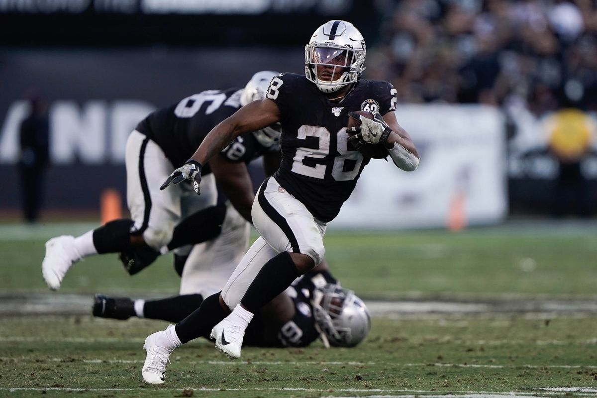 Oakland Raiders running back Josh Jacobs runs with the football in the game against the Cincinnati Bengals during the fourth quarter at the Oakland Coliseum.