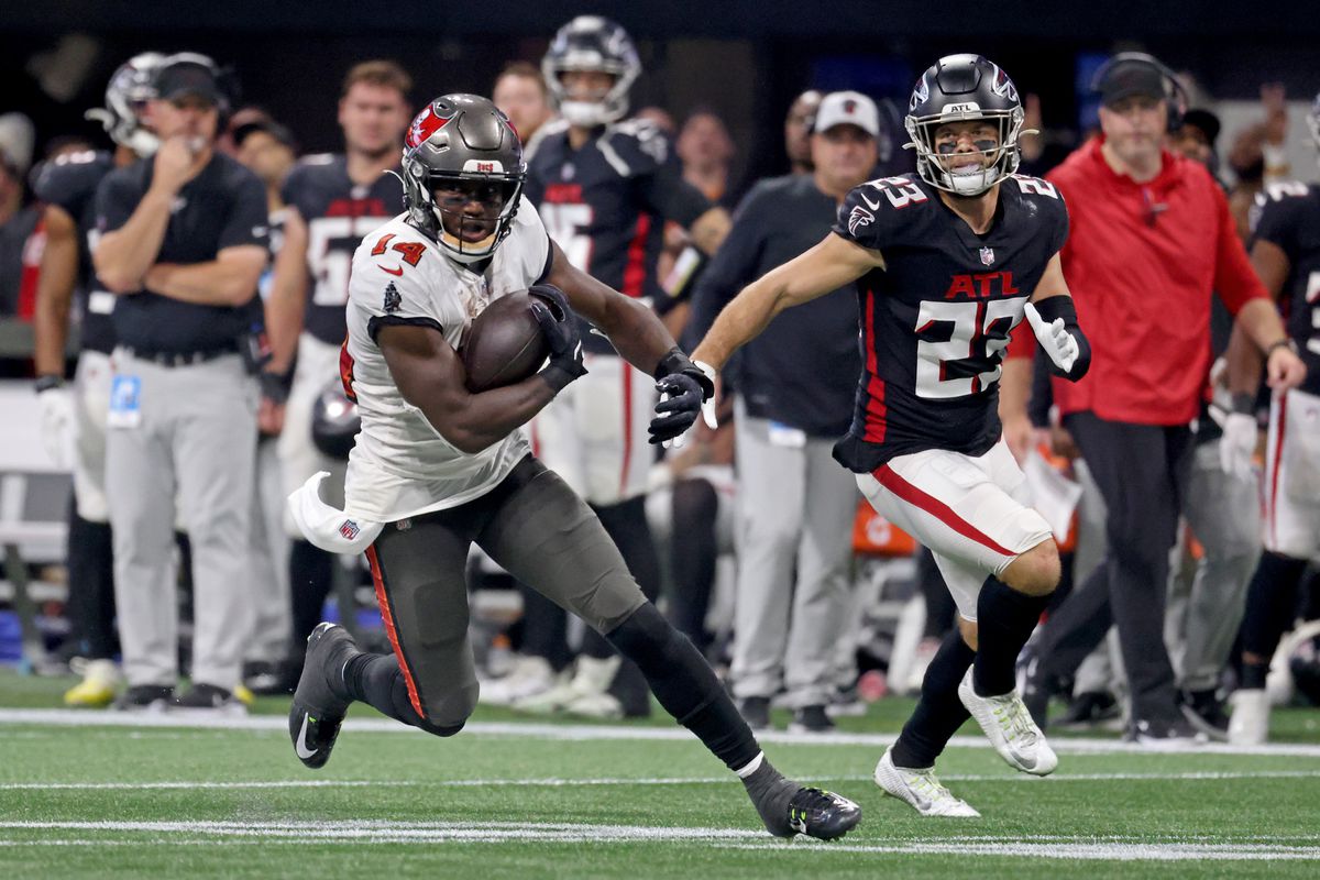 Tampa Bay Buccaneers wide receiver Chris Godwin (14) runs after a catch against Atlanta Falcons safety Erik Harris (23) during the second half at Mercedes-Benz Stadium.