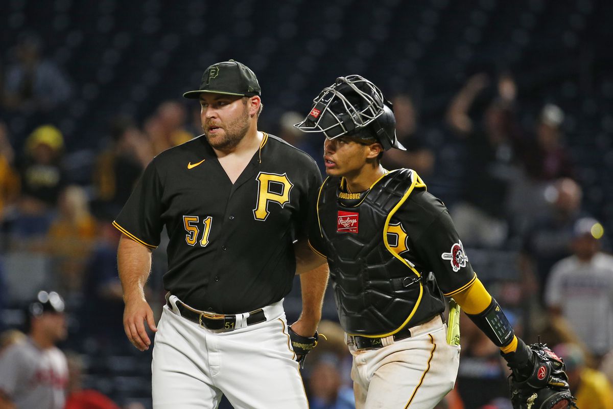 David Bednar and Endy Rodriguez of the Pittsburgh Pirates celebrate after defeating the Atlanta Braves 7-6 during the game at PNC Park on August 7, 2023 in Pittsburgh, Pennsylvania.