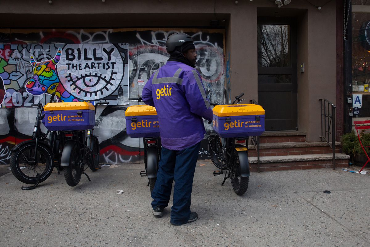 A worker in the East Village gets ready to deliver groceries, Feb. 22, 2022.