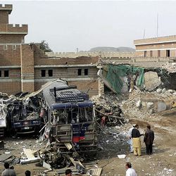 Pakistani officials visit a police station attacked by an alleged suicide bomber in Karak, Pakistan on Feb. 27, 2010.