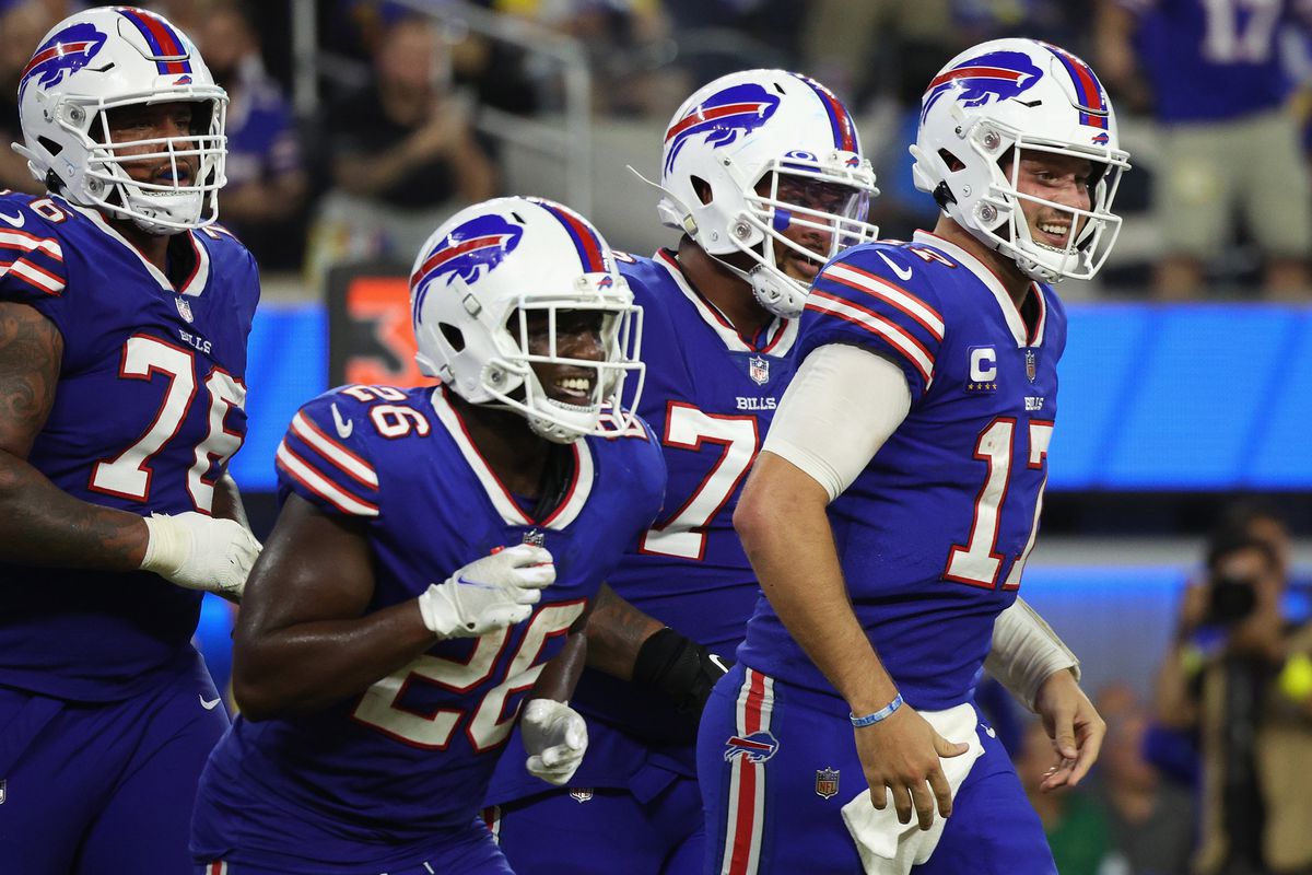 Quarterback Josh Allen #17 of the Buffalo Bills reacts with running back Devin Singletary #26 after Allen scored a four-yard rushing touchdown against the Los Angeles Rams during the fourth quarter of the NFL game at SoFi Stadium on September 08, 2022 in Inglewood, California.