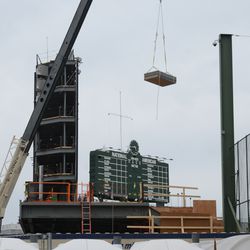 4:45 p.m. Supplies being lifted above the left-field bleachers - 