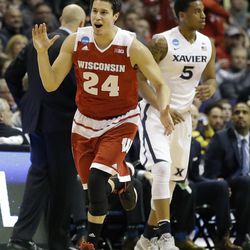 FILE - In this March 20, 2016, file photo, Wisconsin's Bronson Koenig, left, celebrates as he runs past Xavier's Trevon Bluiett after sinking a 3-point basket during the first half in a second-round men's college basketball game in the NCAA Tournament,  in St. Louis. Koenig got Wisconsin into the Sweet 16 by sinking a buzzer-beating 3-pointer against Xavier, but this exceptional shooter also has made seven rebounds in each of Wisconsin’s first two NCAA Tournament games.  