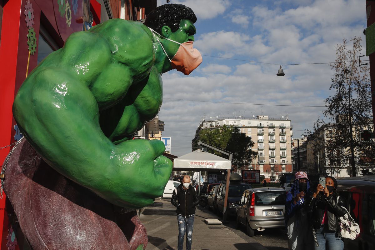 Tourist takes a photo to a figure of Marvel Comics character...