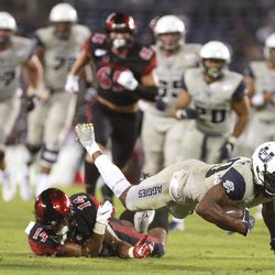 Utah State wide receiver Siaosi Mariner gets tripped by San Diego State’s Tariq Thompson after Mariner caught a pass during the second quarter of an NCAA college football game Saturday, Sept. 21, 2019, in San Diego. (Hayne Palmour IV/The San Diego Union-Tribune via AP)