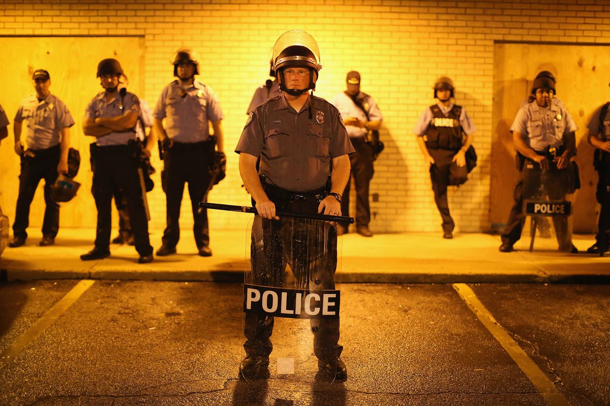 Police stand in a line during protests in Ferguson, Missouri.