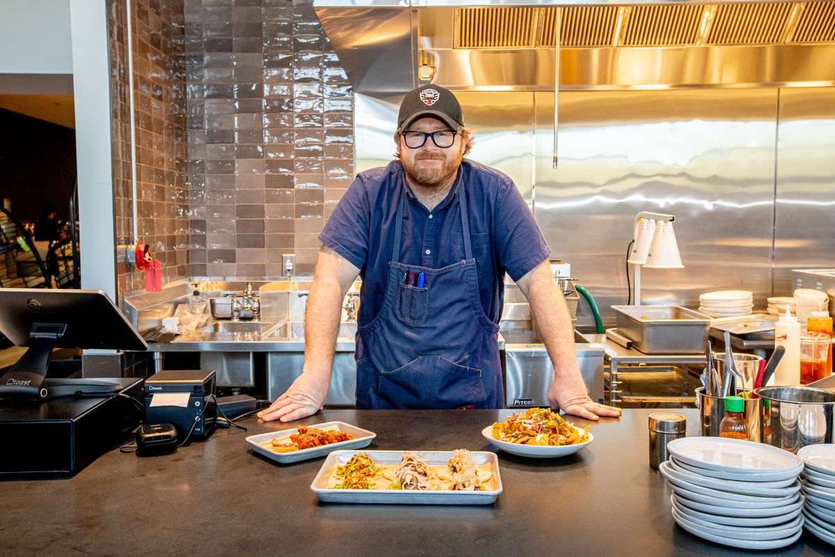 Nate Anda poses for a portrait with new dishes from Hi/Fi Taco