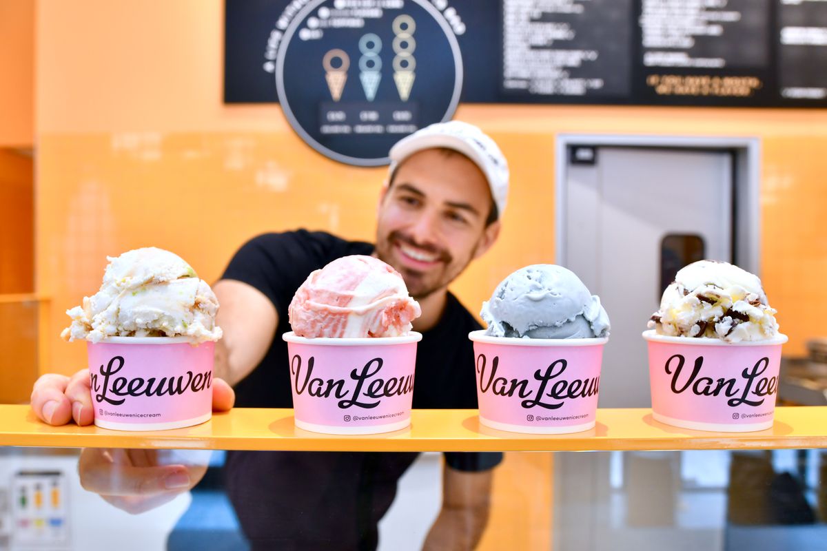 Van Leeuwen CEO Ben Van Leeuwen serves up four cups of ice cream in pink “Leeuwen” cups. The flavors are vegan yuzu sake, blood orange creamsicle, blue jasmine tea, and fior de latte chip.