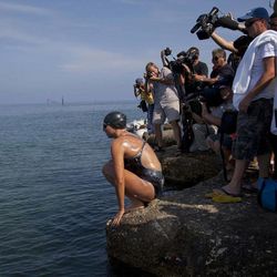 Australian swimmer Chloe McCardel prepares to jump into the water as members of the media surround her at Hemingway Marina to start her swim to Florida from Havana, Cuba, Wednesday, June 12, 2013. McCardel, 29, is bidding to become the first person to make the Straits of Florida crossing without the protection of a shark cage. American Diana Nyad and Australian Penny Palfrey have attempted the crossing four times between them since 2011, but each time threw in the towel part way through due to injury, jellyfish stings or strong currents. Australian Susie Maroney did it in 1997, but with a shark cage. 
