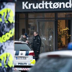 The scene outside the Copenhagen cafe, with bullet marked window, where a gunman opened fire Saturday, Feb. 14, 2015, in what is seen as a likely terror attack against a free speech event organized by an artist who had caricatured the Prophet Muhammad. The police believe there was only one shooter in the attack on a Copenhagen cafe that left one person dead and three police officers wounded during a free speech event. 